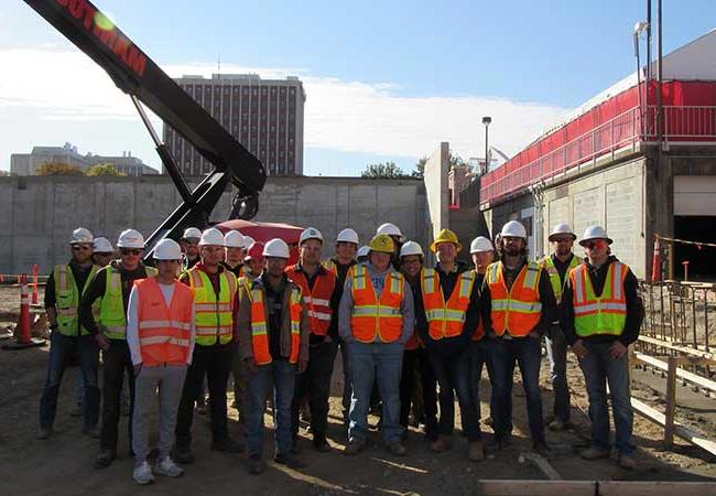 Construction Management students pose for a group photo at a construction site